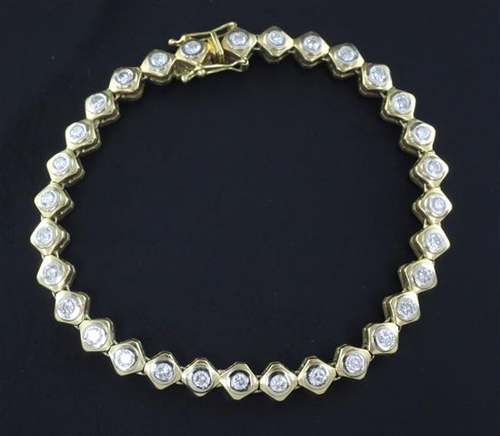 An 18ct gold & diamond line bracelet, 7in.